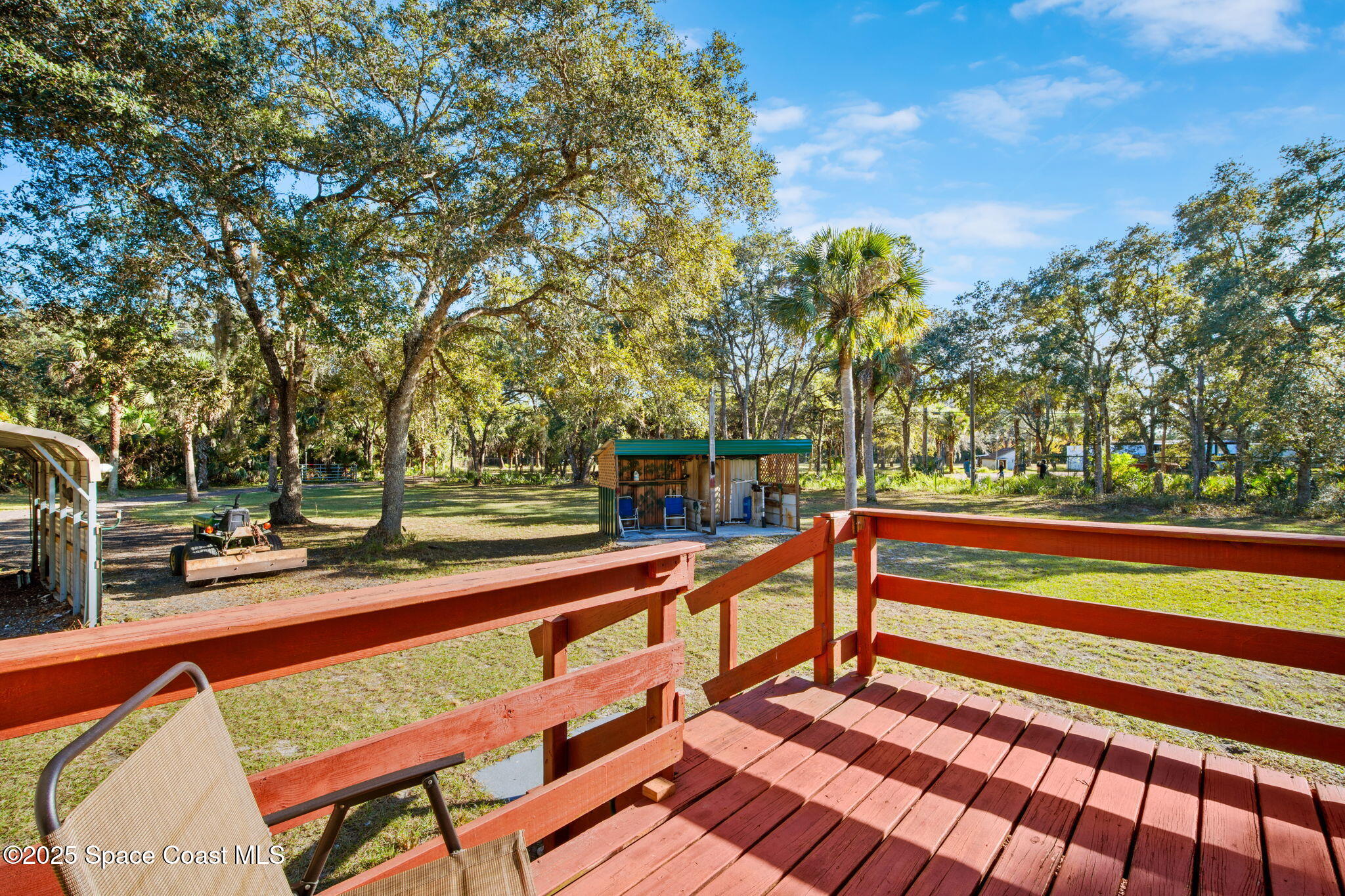6672 Bear Trail Cocoa, FL 32926 - Photo 4 of 46 a view of a patio with chairs and wooden fence
