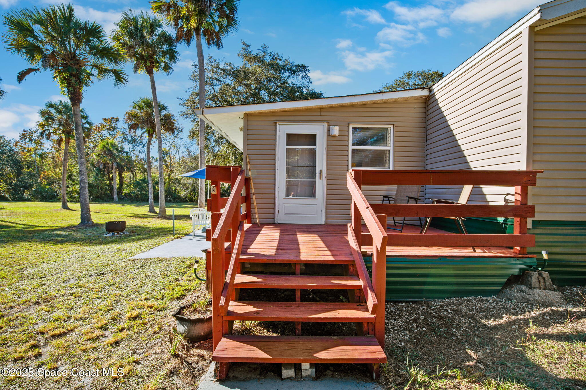 6672 Bear Trail Cocoa, FL 32926 - Photo 5 of 46 a backyard of a house with barbeque oven table and chairs