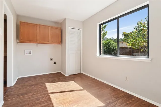 a view of a backyard with brick wall and plants