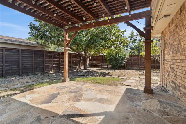 a backyard of a house with table and chairs