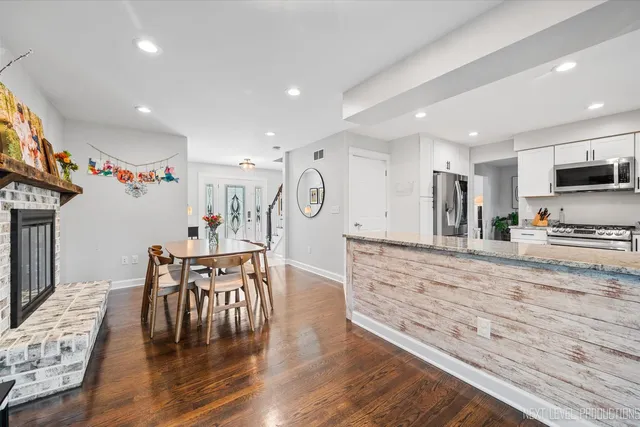 a view of dining table chairs and wooden floor