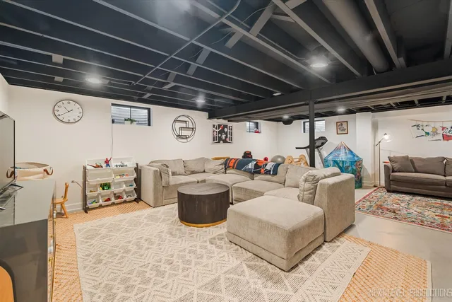 a living room with furniture and a chandelier