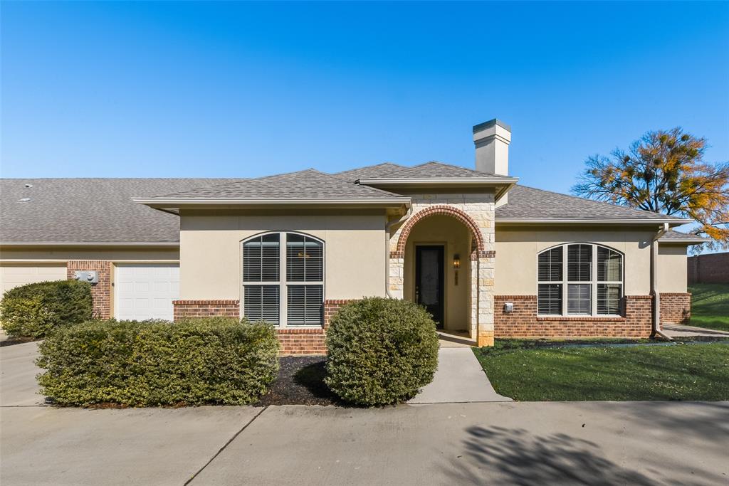8841 Creek Run Road, Unit 403 Fort Worth, TX 76120 - Photo 1 of 26 front view of a house with a garden