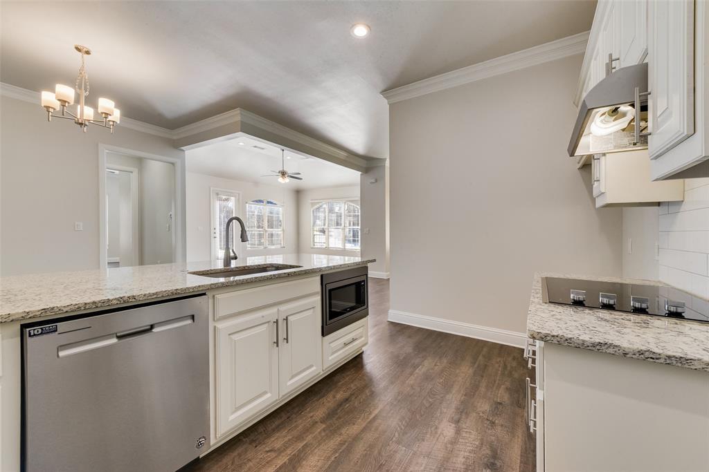8841 Creek Run Road, Unit 403 Fort Worth, TX 76120 - Photo 11 of 26 a kitchen with granite countertop a sink cabinets and wooden floor