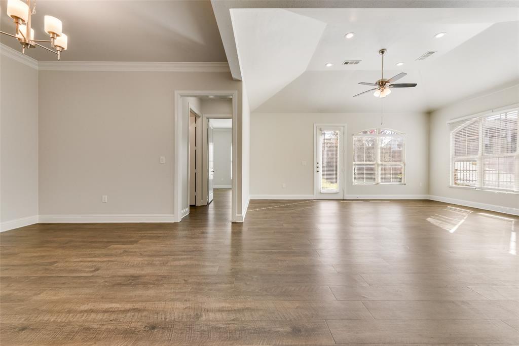 8841 Creek Run Road, Unit 403 Fort Worth, TX 76120 - Photo 13 of 26 an empty room with wooden floor chandelier and windows