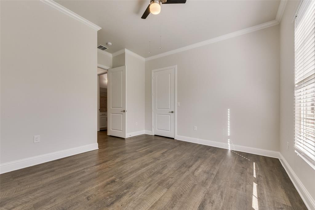 8841 Creek Run Road, Unit 403 Fort Worth, TX 76120 - Photo 19 of 26 an empty room with wooden floor cabinet and windows