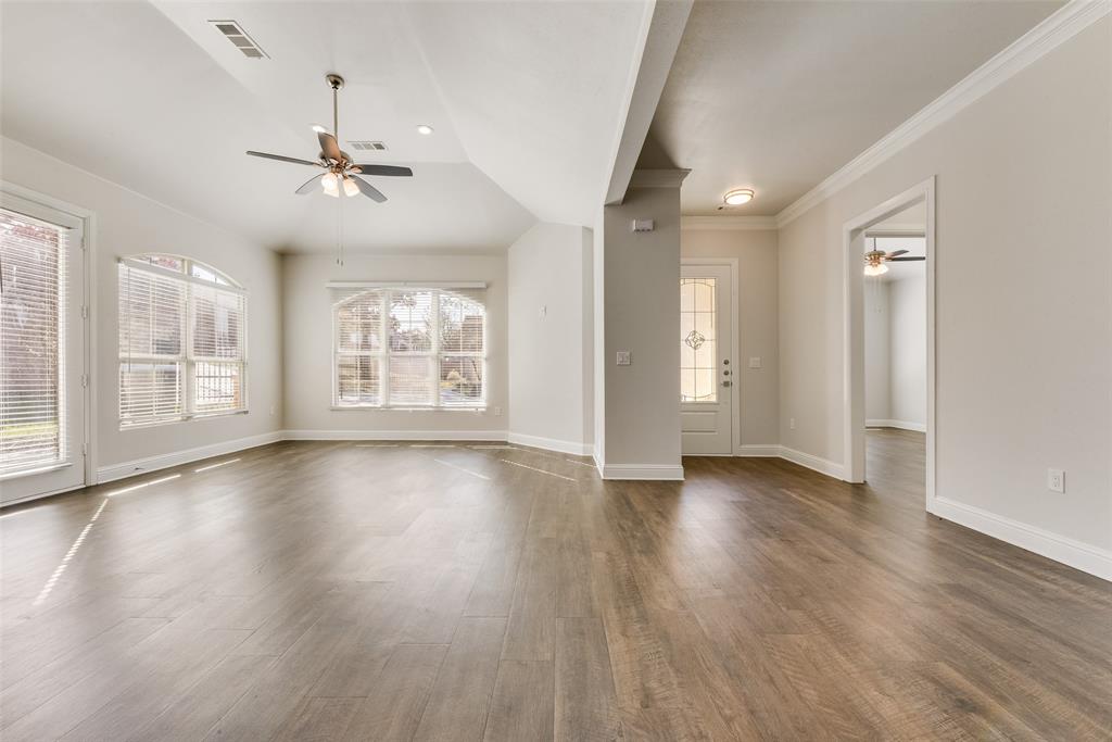 8841 Creek Run Road, Unit 403 Fort Worth, TX 76120 - Photo 3 of 26 a view of an empty room with wooden floor and a window
