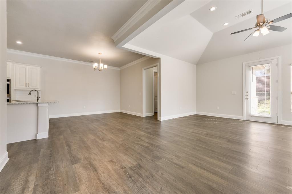 8841 Creek Run Road, Unit 403 Fort Worth, TX 76120 - Photo 5 of 26 a view of empty room with wooden floor and fan