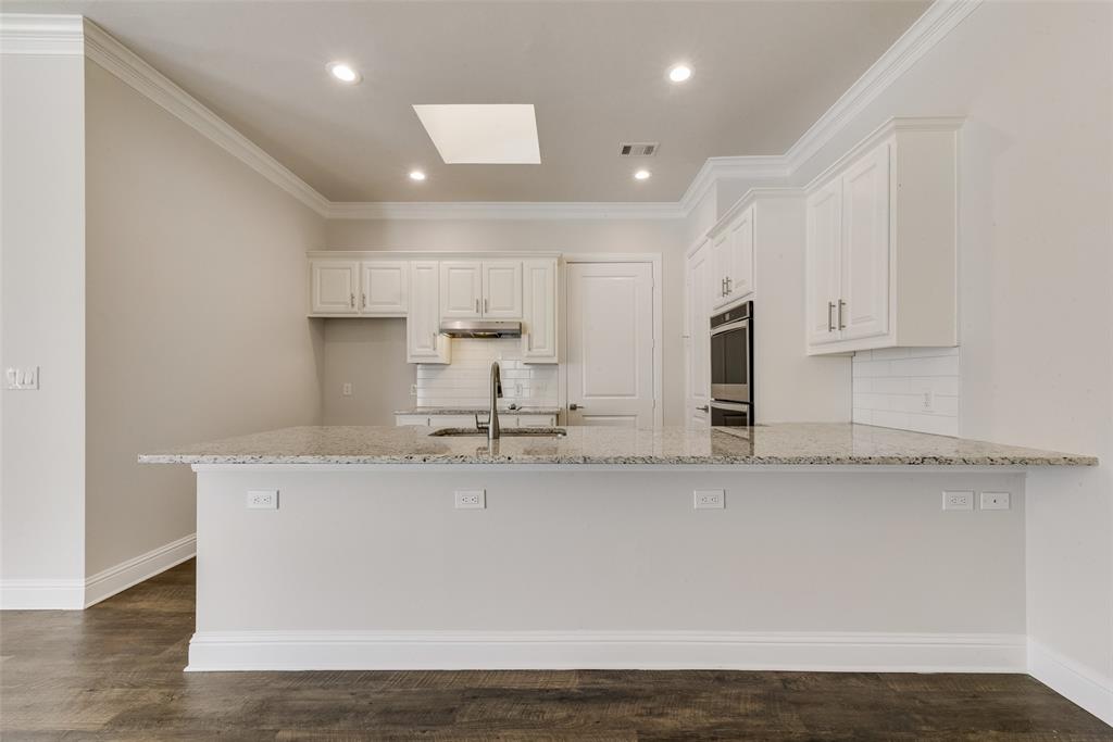 8841 Creek Run Road, Unit 403 Fort Worth, TX 76120 - Photo 9 of 26 a large kitchen with stainless steel appliances granite countertop a granite counter tops and a stove