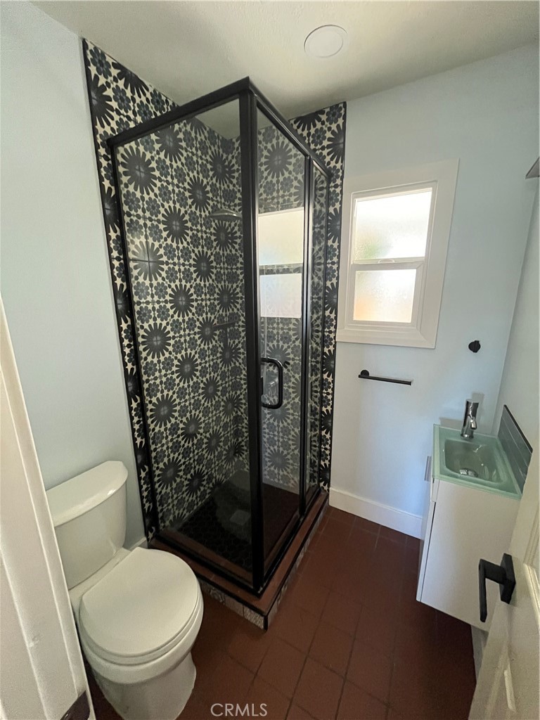 3438 Locust Street Riverside, CA 92501 - Photo 24 of 38 a bathroom with a toilet and shower