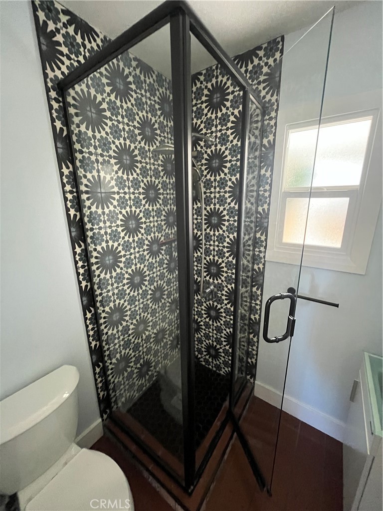 3438 Locust Street Riverside, CA 92501 - Photo 26 of 38 a bathroom with a toilet and shower