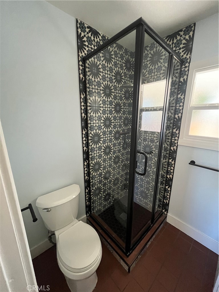 3438 Locust Street Riverside, CA 92501 - Photo 28 of 38 a bathroom with a toilet and a shower