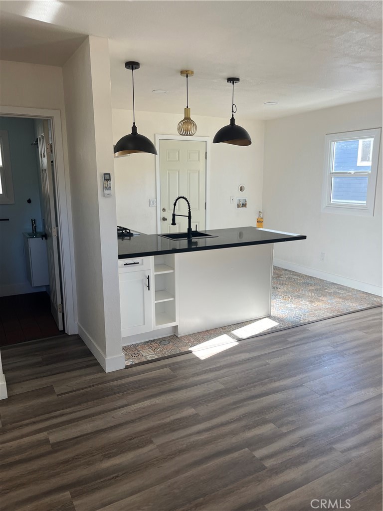 3438 Locust Street Riverside, CA 92501 - Photo 8 of 38 a kitchen with stainless steel appliances granite countertop a sink a stove and a wooden floors