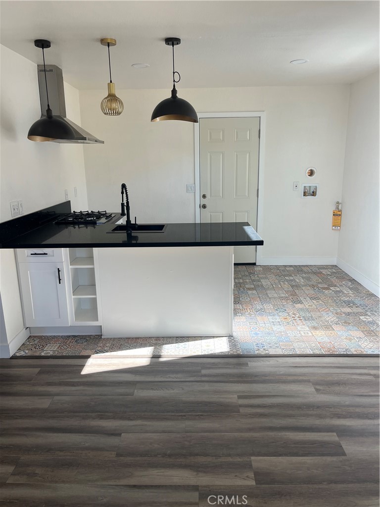 3438 Locust Street Riverside, CA 92501 - Photo 9 of 38 a view of kitchen with granite countertop white cabinets and wooden floor