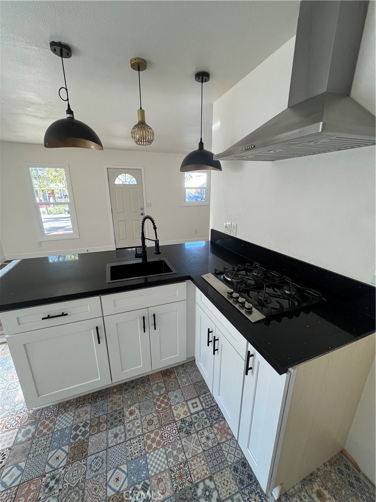 3438 Locust Street Riverside, CA 92501 - Photo 10 of 38 a kitchen with stainless steel appliances a sink a stove a refrigerator and cabinets