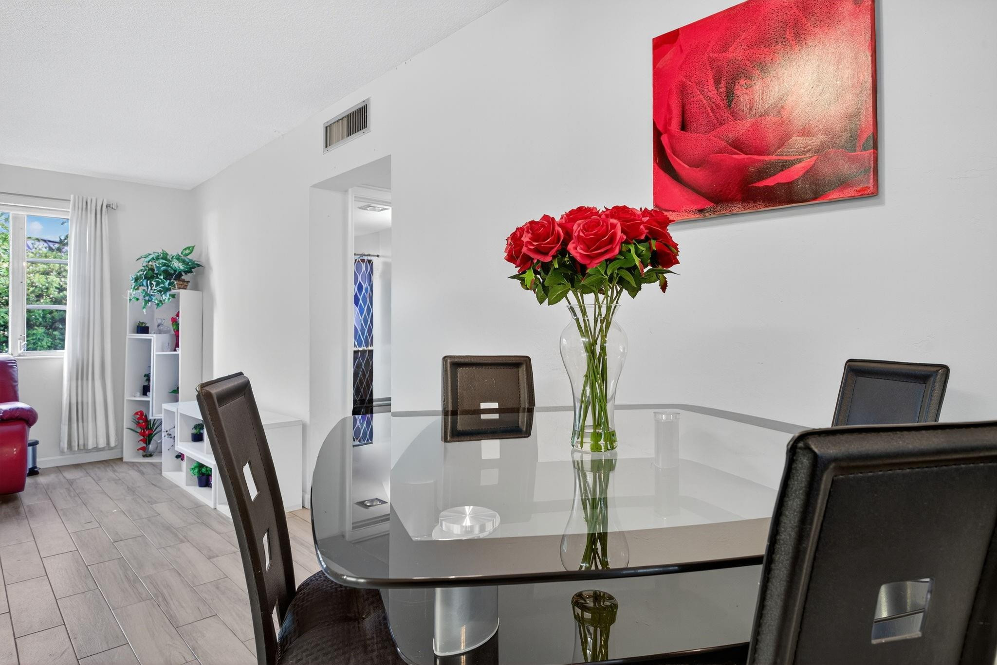 418 South Cypress Road, Unit 110 Pompano Beach, FL 33060 - Photo 8 of 28 a view of a dining room with furniture and flowers