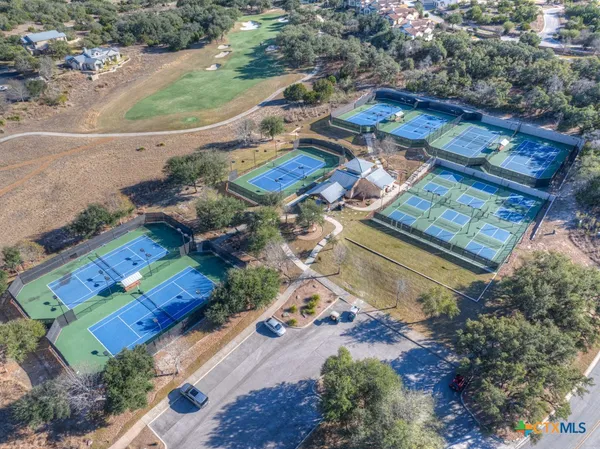 an aerial view of residential houses with outdoor space