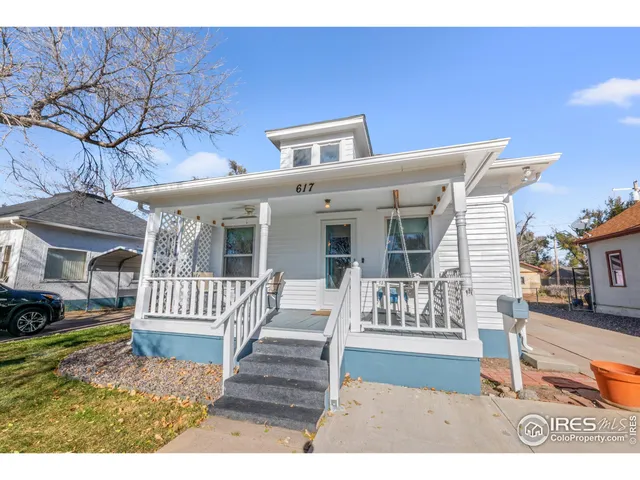 a view of a house with a wooden bench