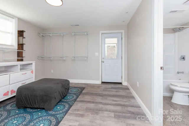 a bedroom with a bed and a view of bathroom