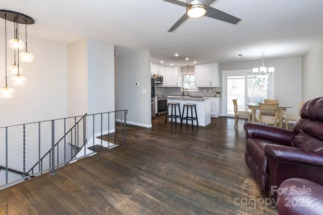 a view of a dining room with furniture wooden floor and chandelier