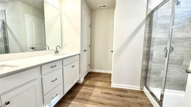 a spacious bathroom with a double vanity sink and mirror