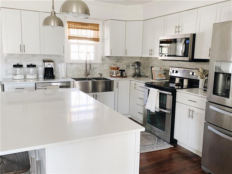 109 Mellingertown Road Mount Pleasant, PA 15666 - Photo 5 of 21 A gorgeous, white kitchen with island, quartz counters and stainless appliances