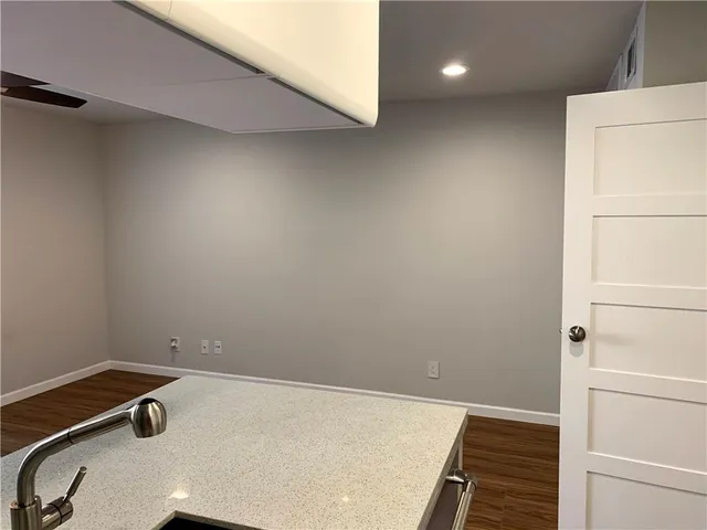 a view of a room with wooden floor and cabinet