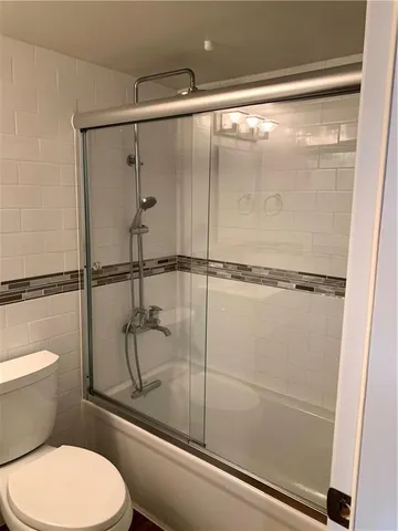 a bathroom with a shower and a toilet