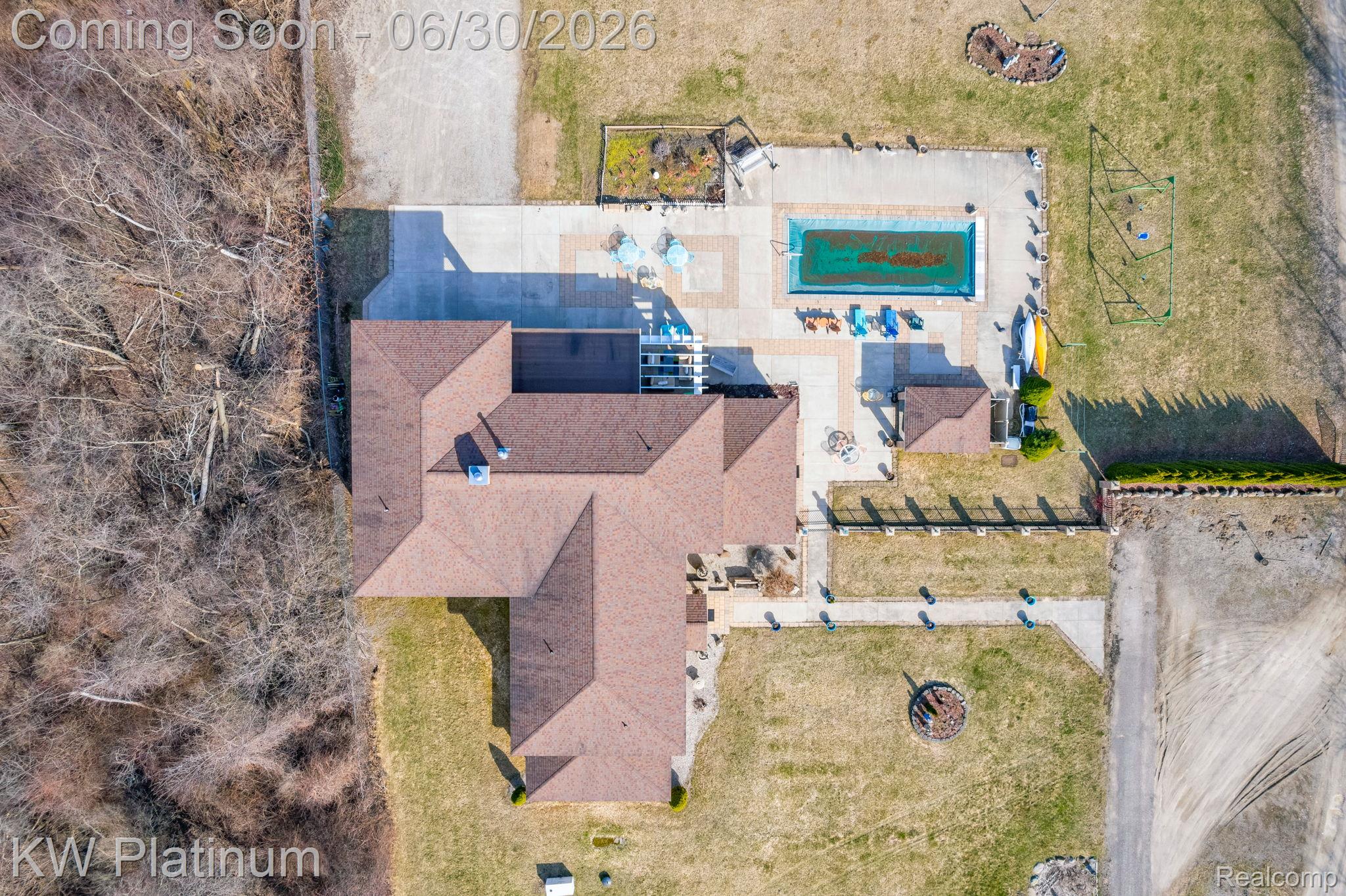2235 South Lake Shore Road Harbor Beach, MI 48441 - Photo 94 of 99 Property featuring a multi-gabled roofline, an in-ground swimming pool, a concrete pool deck, and surrounding green space