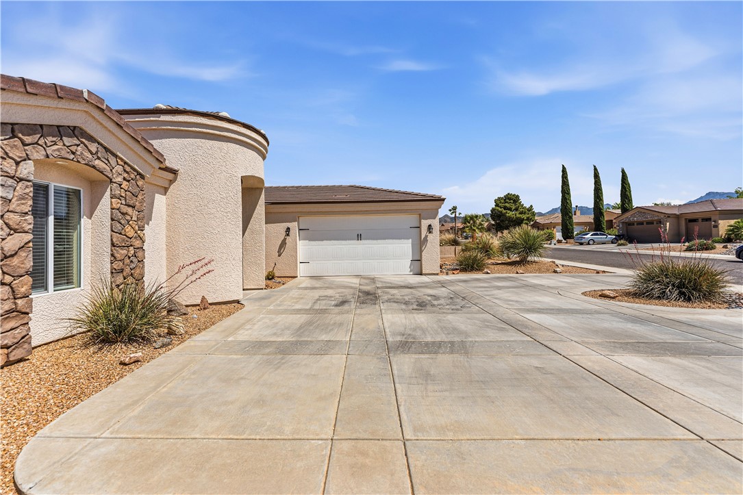 3315 Rainbow Mine Road Kingman, AZ 86401 - Photo 48 of 54 The property features a stone and stucco exterior, an attached garage, and a concrete driveway