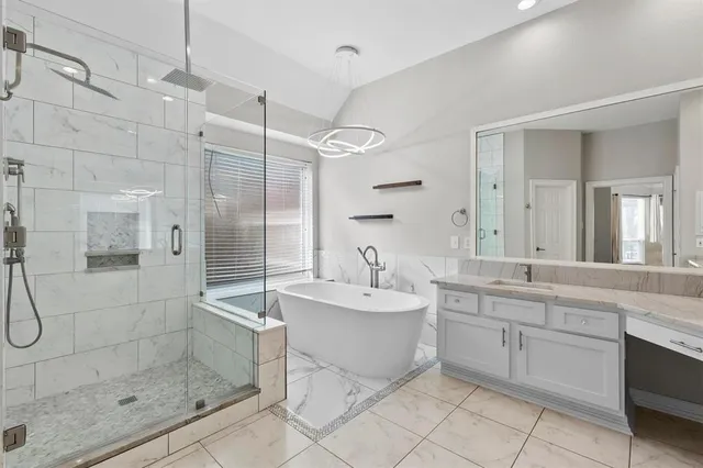 a spacious bathroom with a shower sink and mirror