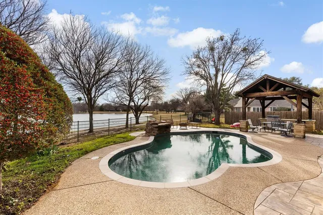 a view of a swimming pool with a yard