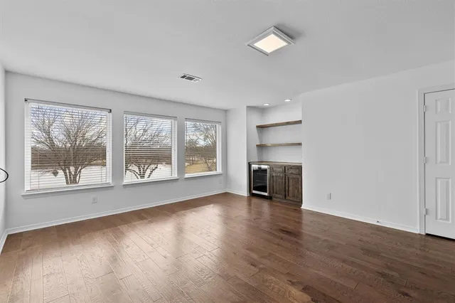wooden floor in an empty room with a fireplace