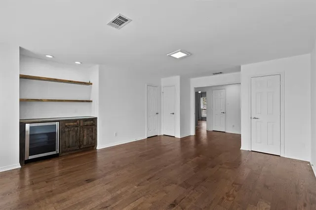 a view of an empty room with a fireplace and a window