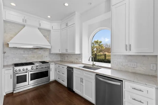 a kitchen with appliances cabinets and a sink