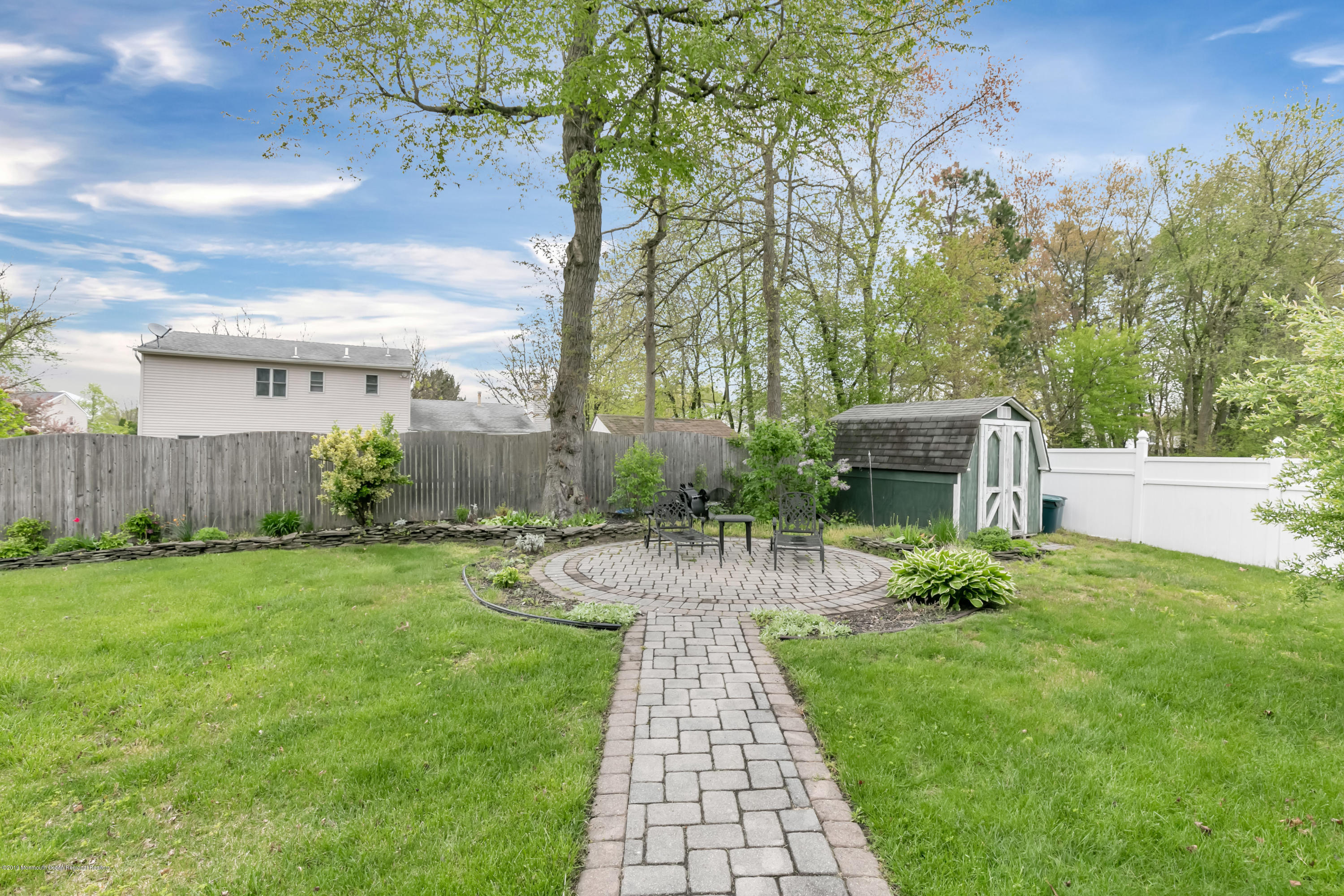 24 Starlight Road Howell, NJ 07731 - Photo 22 of 26 a view of a patio with a table and a chairs