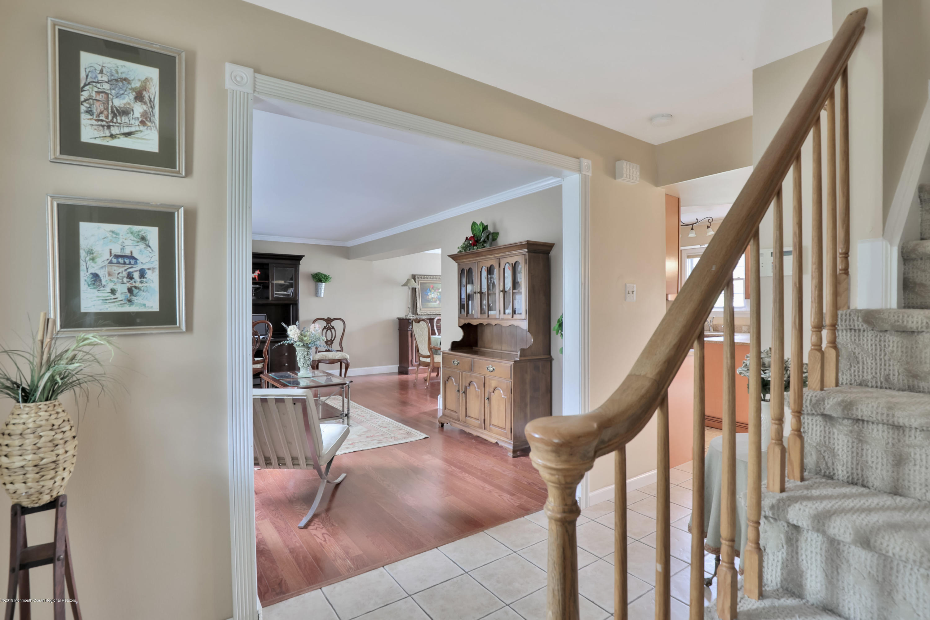 24 Starlight Road Howell, NJ 07731 - Photo 5 of 26 a living room with furniture and stairs