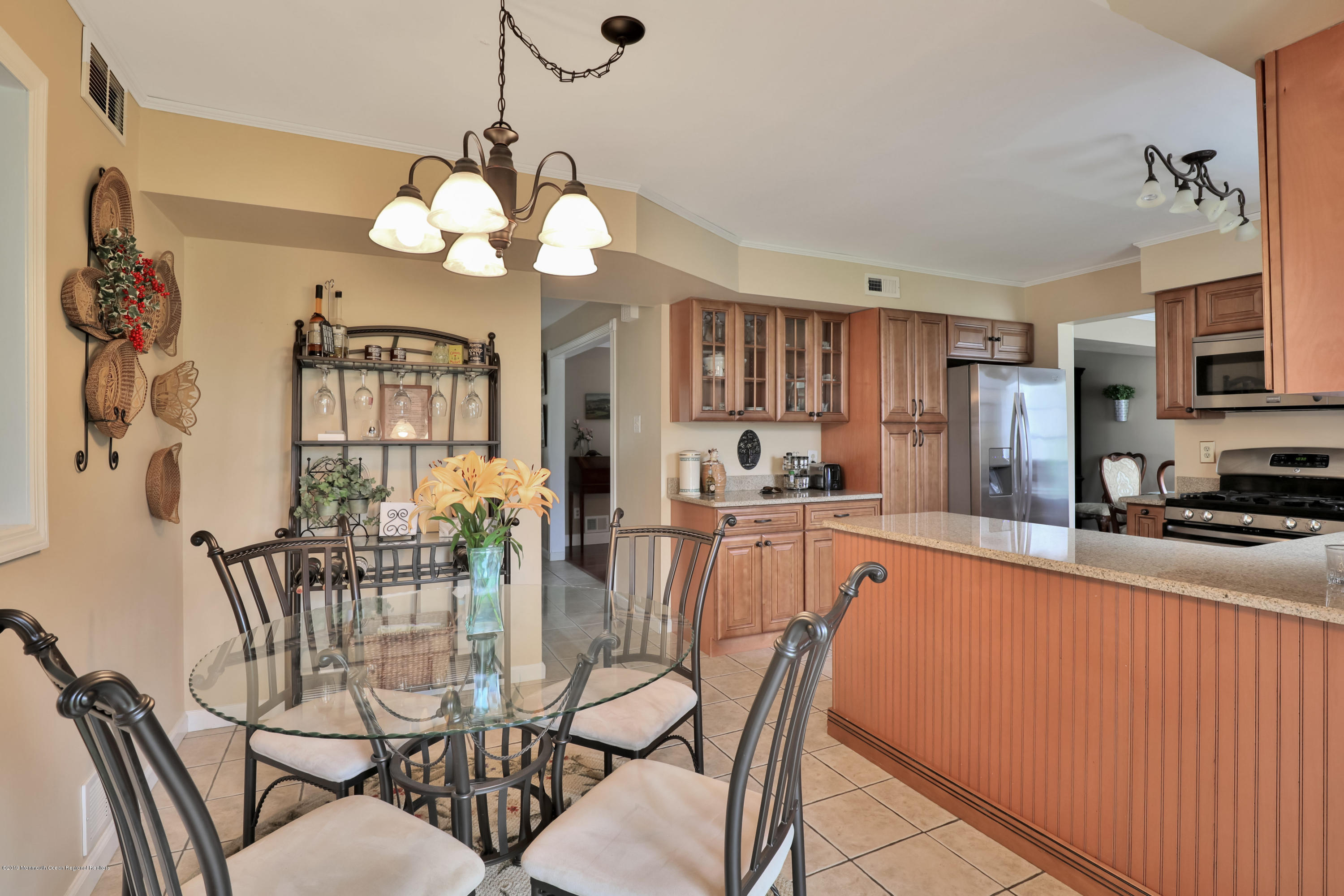 24 Starlight Road Howell, NJ 07731 - Photo 7 of 26 a view of a dining room with furniture and a chandelier