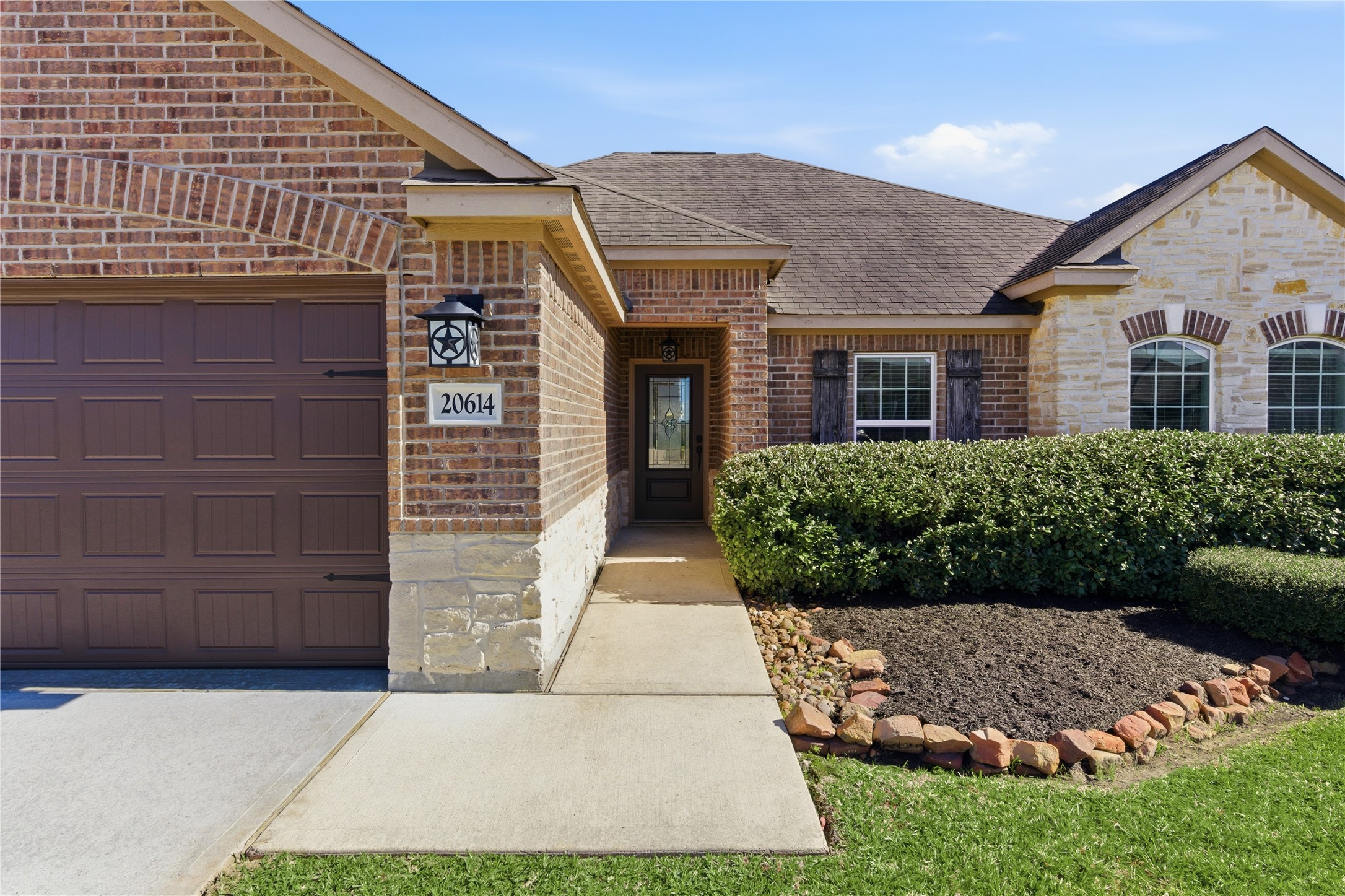 20614 Silver Tea Avenue Hockley, TX 77447 - Photo 2 of 27 a front view of a house with a garden