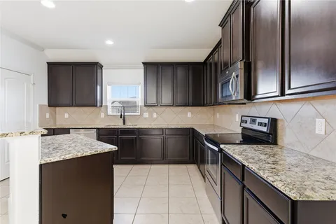 a bathroom with a granite countertop sink a mirror and a vanity