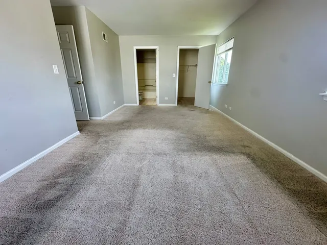 an empty room with windows and entrance