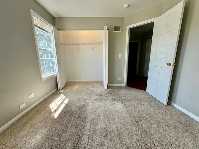 a view of entryway with wooden floor and front door