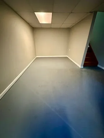 an empty room with a empty space and windows