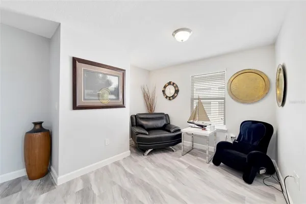 a living room with furniture and a mirror