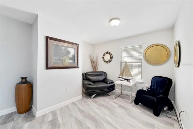 a living room with furniture and a mirror