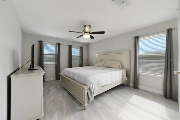 a bedroom with a bed and a chandelier