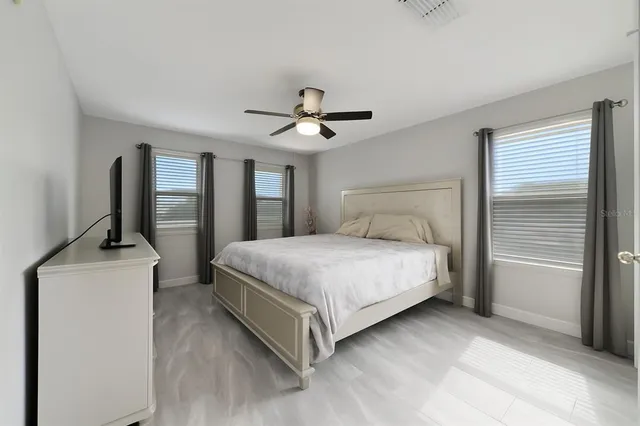 a bedroom with a bed and a chandelier