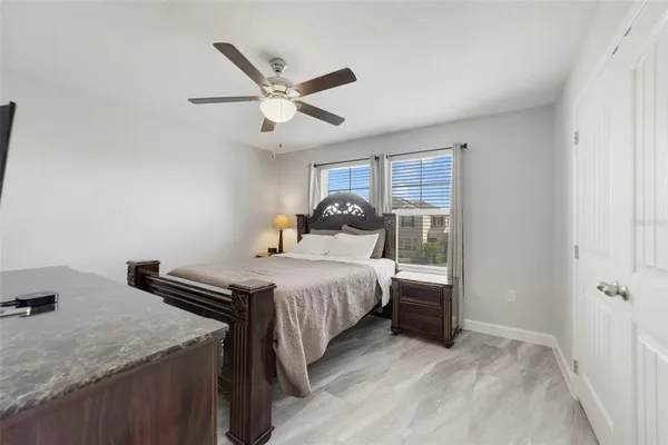 a bedroom with a bed and a chandelier