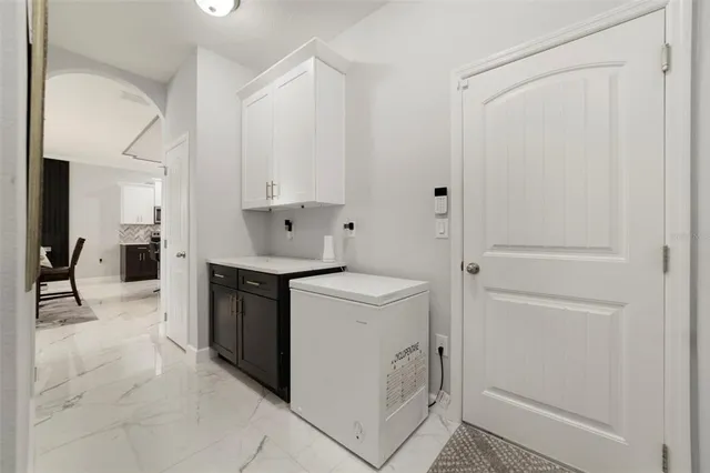 a kitchen with white cabinets and white appliances