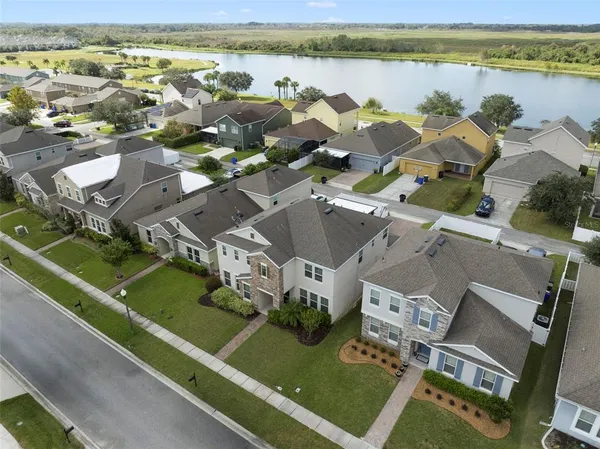 an aerial view of residential houses with outdoor space and river
